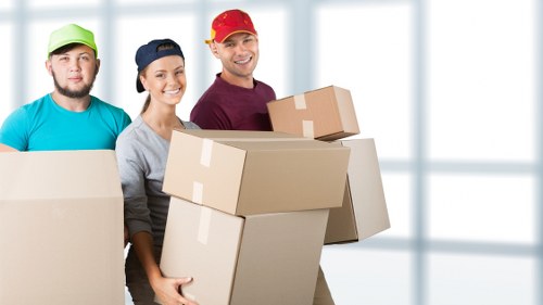 Packed moving boxes and furniture ready for transport in Camden