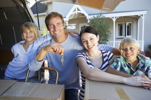 Professional man and van service handling moving boxes in Camden